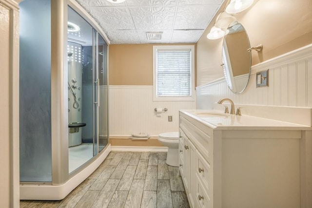 998 Wood, Swansea, MA 02777 - bathroom with wood finished floors, a wainscoted wall, a shower stall, vanity, and toilet