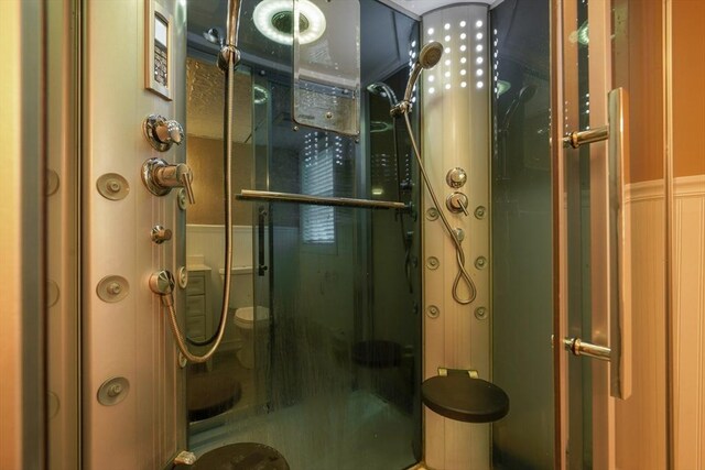 998 Wood, Swansea, MA 02777 - full bathroom with a shower stall, toilet, and a wainscoted wall