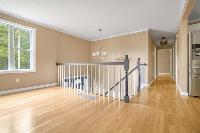 998 Wood, Swansea, MA 02777 - corridor with a chandelier, light wood-type flooring, baseboards, and crown molding