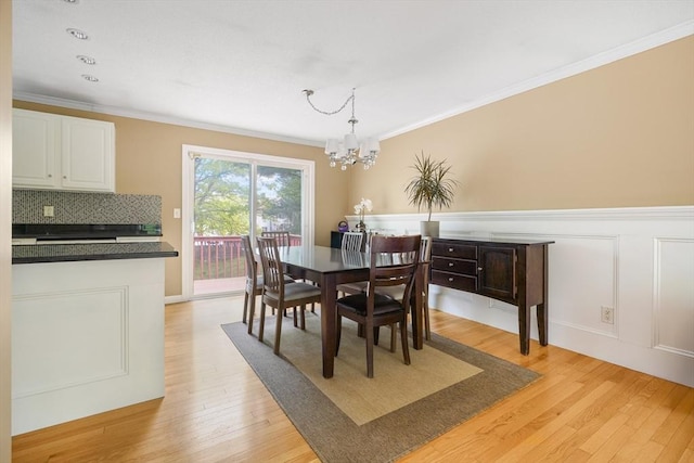 998 Wood, Swansea, MA 02777 - dining room featuring a chandelier, light wood-style floors, ornamental molding, and wainscoting