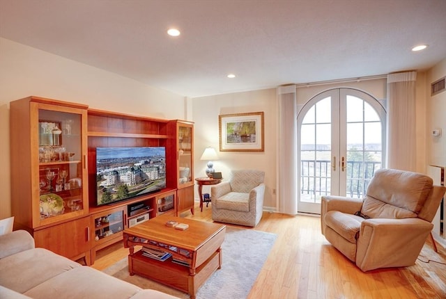 living room with french doors and light hardwood / wood-style floors