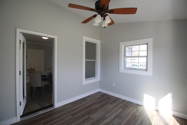 unfurnished bedroom with a ceiling fan, dark wood-type flooring, baseboards, and vaulted ceiling