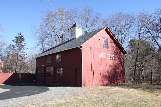 view of barn with fence