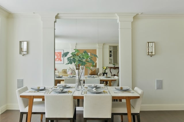 dining area with ornamental molding, dark wood-type flooring, and ornate columns