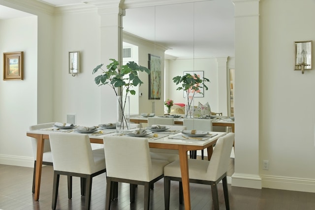 dining area featuring ornamental molding, decorative columns, and dark hardwood / wood-style flooring