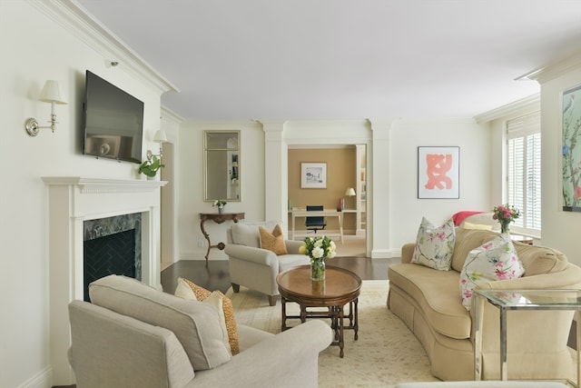 living room featuring light hardwood / wood-style flooring, a premium fireplace, and crown molding