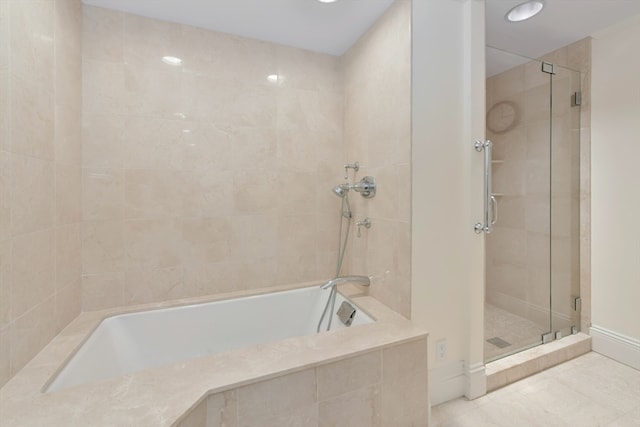 bathroom featuring shower with separate bathtub and tile patterned floors