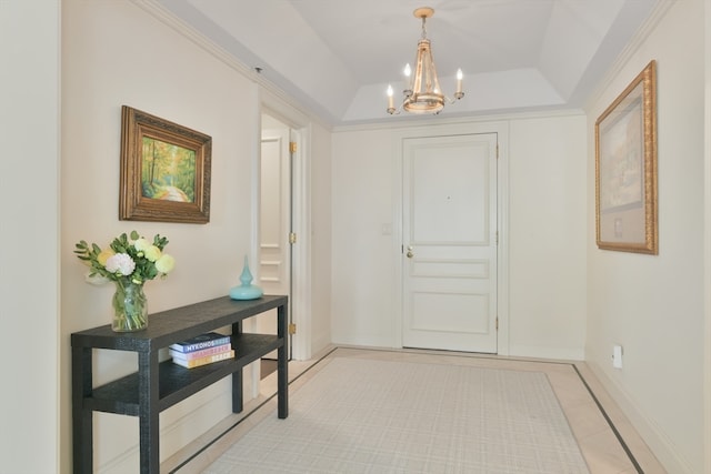 interior space featuring a tray ceiling, a chandelier, and light tile patterned floors