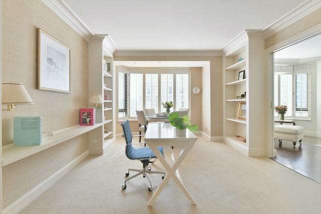 office area featuring built in shelves, crown molding, and a healthy amount of sunlight