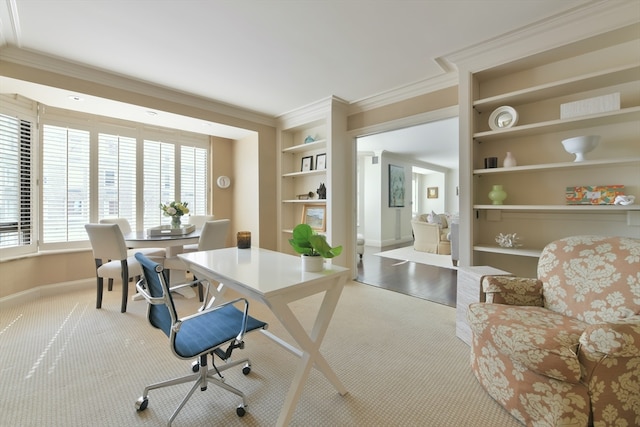 home office featuring carpet floors, ornamental molding, and built in features