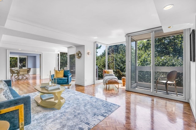 living room featuring light parquet flooring and floor to ceiling windows