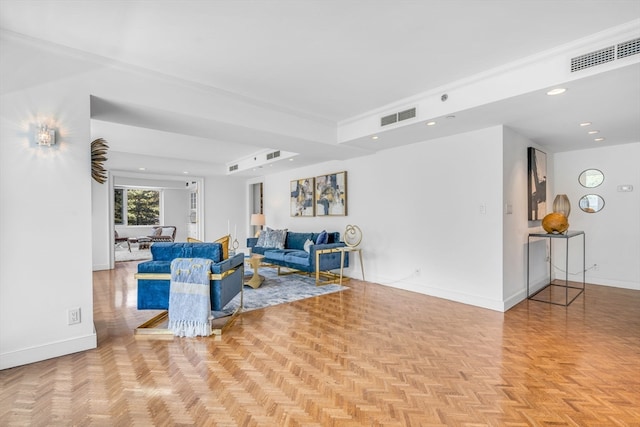 living room featuring a tray ceiling and light parquet flooring