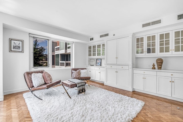 living area featuring light parquet flooring