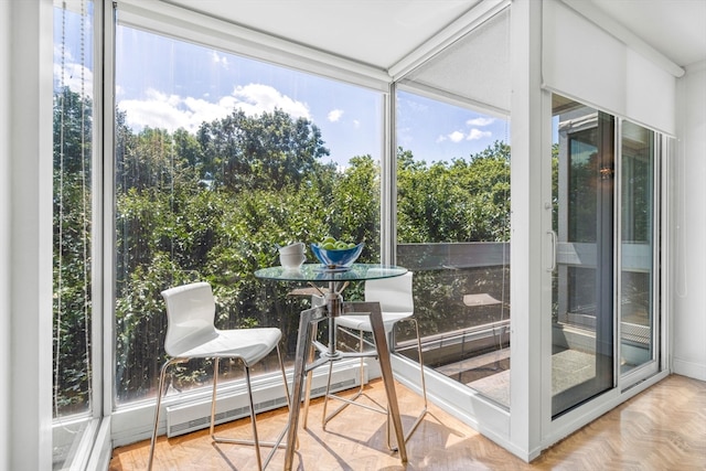 sunroom featuring a baseboard heating unit