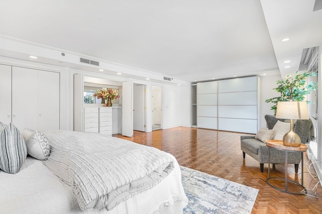 bedroom featuring parquet floors and a tray ceiling