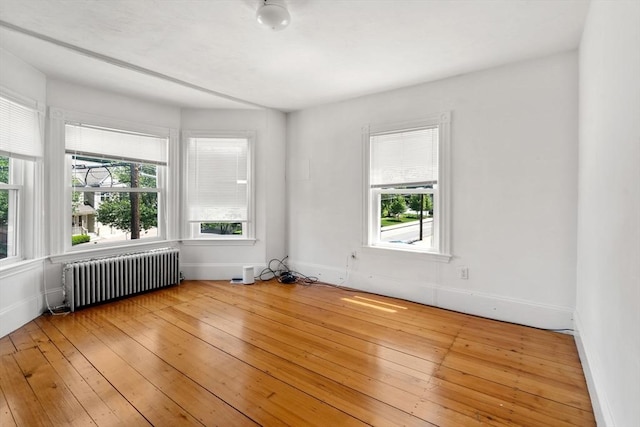 379 Hunnewell St, Needham, MA 02494 - empty room with radiator heating unit, light wood-type flooring, and baseboards