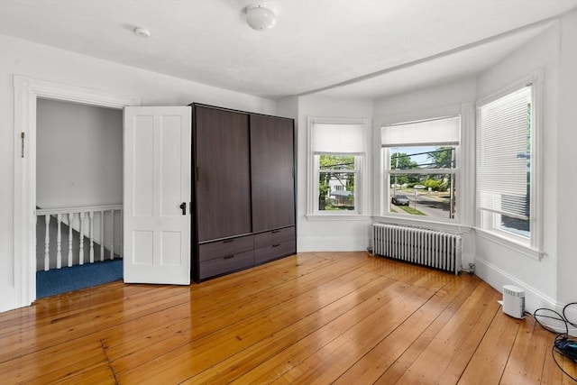 379 Hunnewell St, Needham, MA 02494 - unfurnished bedroom featuring radiator, light wood-type flooring, and baseboards