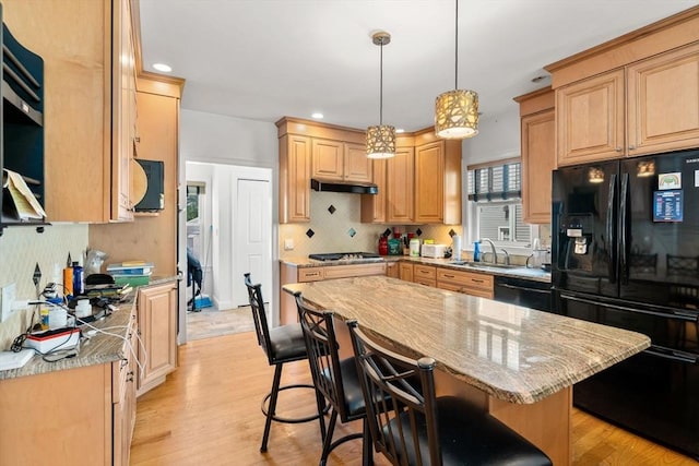 379 Hunnewell St, Needham, MA 02494 - kitchen with black appliances, a sink, under cabinet range hood, light wood-style flooring, and recessed lighting
