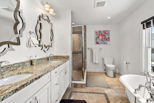 379 Hunnewell St, Needham, MA 02494 - bathroom featuring a shower stall, a freestanding bath, double vanity, toilet, and recessed lighting