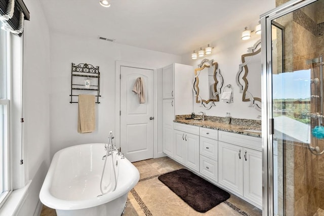 379 Hunnewell St, Needham, MA 02494 - bathroom featuring double vanity, a freestanding bath, and a stall shower