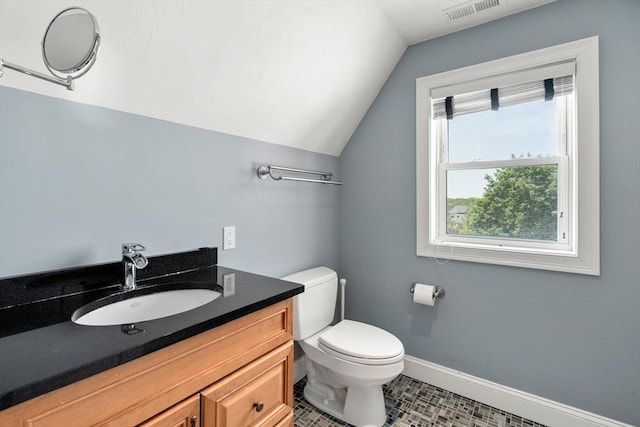 379 Hunnewell St, Needham, MA 02494 - bathroom with vaulted ceiling, toilet, vanity, baseboards, and tile patterned flooring