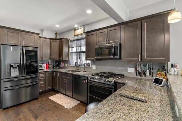 379 Hunnewell St, Needham, MA 02494 - kitchen with appliances with stainless steel finishes, a sink, dark brown cabinetry, light stone counters, and dark wood-type flooring