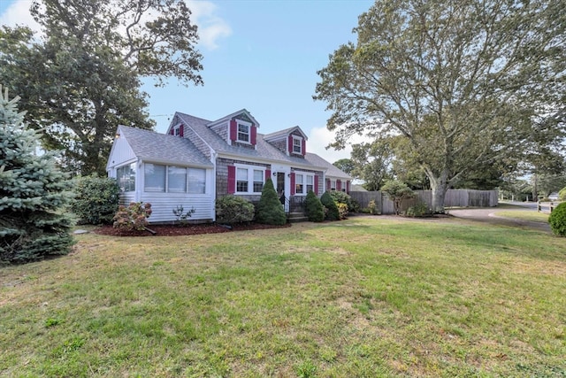 new england style home featuring a front lawn