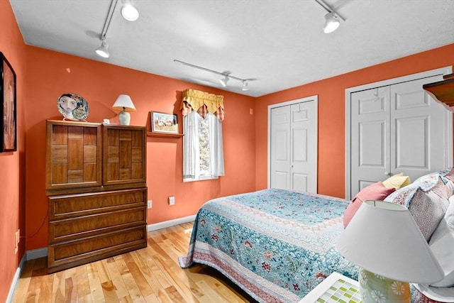 46 Michael Rd Unit 46, Bridgewater, MA 02324 - bedroom featuring rail lighting, multiple closets, and wood-type flooring
