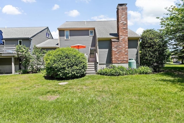 46 Michael Rd Unit 46, Bridgewater, MA 02324 - rear view of house featuring a yard, a chimney, and roof with shingles