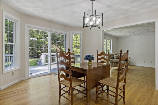 22 Mikayla Ann Dr, Rehoboth, MA 02769 - dining area featuring light wood-style floors, baseboards, and a chandelier