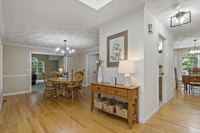 22 Mikayla Ann Dr, Rehoboth, MA 02769 - dining space with a chandelier, light wood finished floors, and baseboards