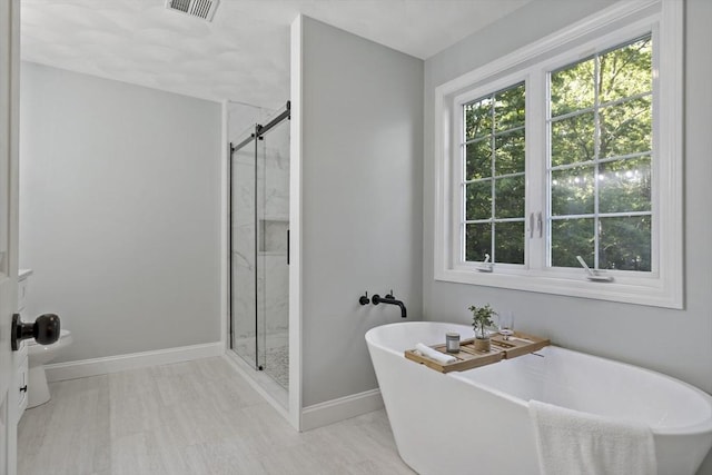 22 Mikayla Ann Dr, Rehoboth, MA 02769 - full bathroom featuring a shower stall, a freestanding tub, and baseboards