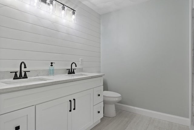 22 Mikayla Ann Dr, Rehoboth, MA 02769 - bathroom featuring toilet, wood walls, baseboards, and double vanity