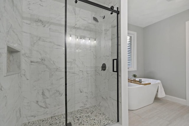 22 Mikayla Ann Dr, Rehoboth, MA 02769 - bathroom featuring a freestanding tub, a marble finish shower, and baseboards