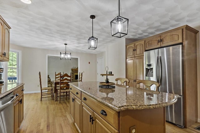 22 Mikayla Ann Dr, Rehoboth, MA 02769 - kitchen with appliances with stainless steel finishes, a kitchen island, light wood-type flooring, and dark stone countertops