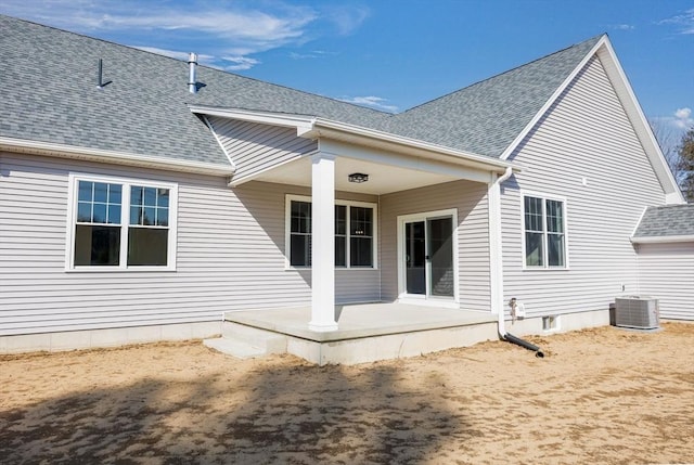 rear view of property with a patio, cooling unit, and a shingled roof