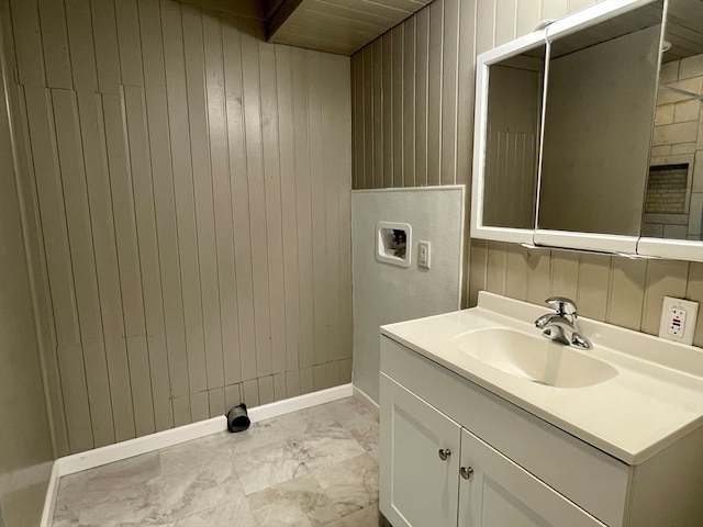 bathroom featuring vanity and wooden walls