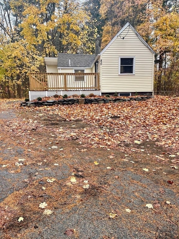 rear view of house featuring a deck