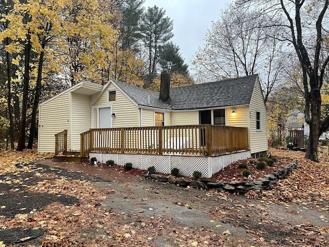 back of property featuring a wooden deck