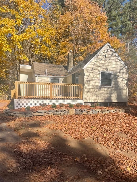 view of side of home featuring a wooden deck