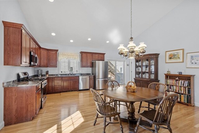 dining room featuring a wealth of natural light, light wood-type flooring, a chandelier, and recessed lighting