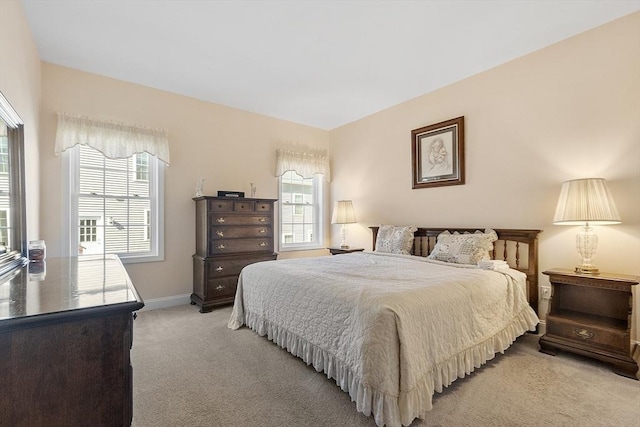 bedroom featuring baseboards and light carpet