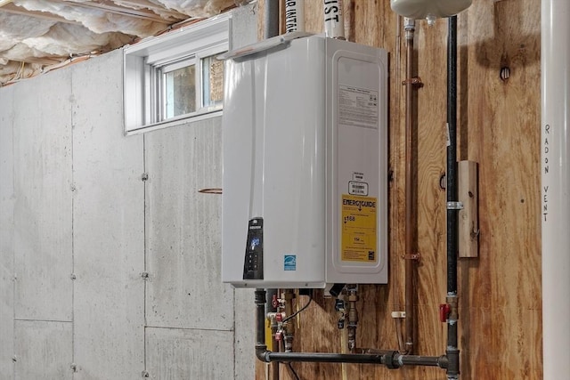 utility room featuring water heater