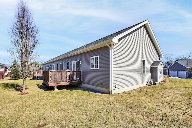 view of side of home with a wooden deck and a yard