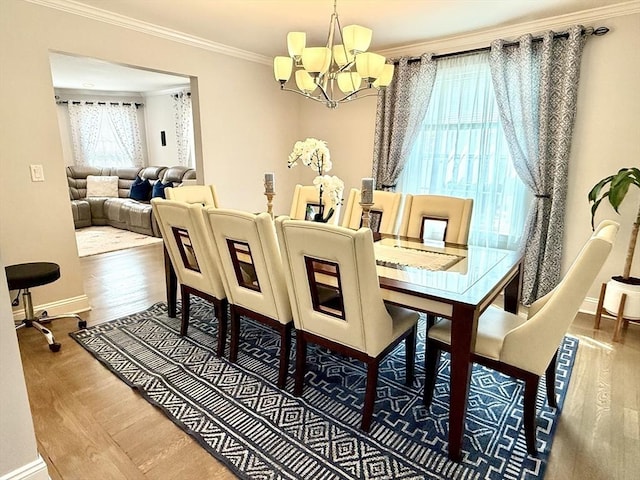 21 Florence Ave, Lowell, MA 01851 - dining room featuring a chandelier, wood finished floors, crown molding, and baseboards