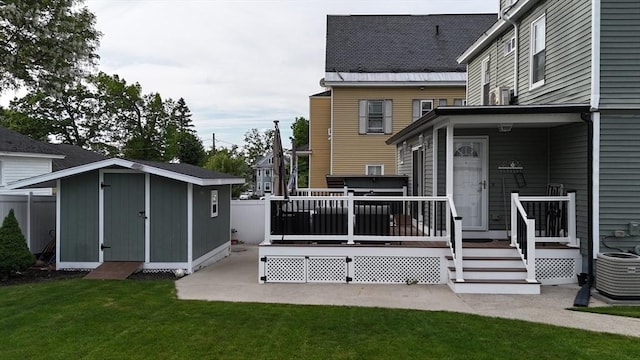 21 Florence Ave, Lowell, MA 01851 - back of house featuring central AC, a lawn, and a deck