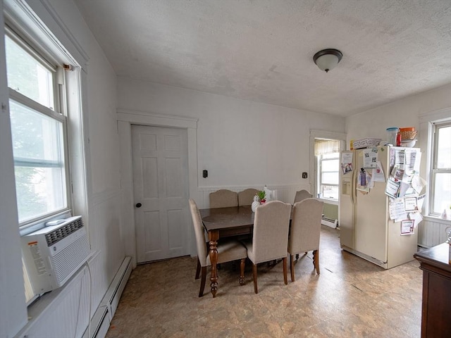 42 Morton St, Lawrence, MA 01841 - dining space featuring light flooring, a textured ceiling, healthy amount of natural light, and a baseboard heating unit