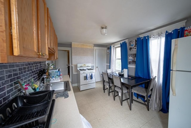 42 Morton St, Lawrence, MA 01841 - kitchen featuring white appliances, a sink, light flooring, brown cabinets, and light countertops