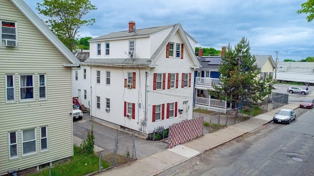 42 Morton St, Lawrence, MA 01841 - view of home's exterior featuring a chimney and a shingled roof