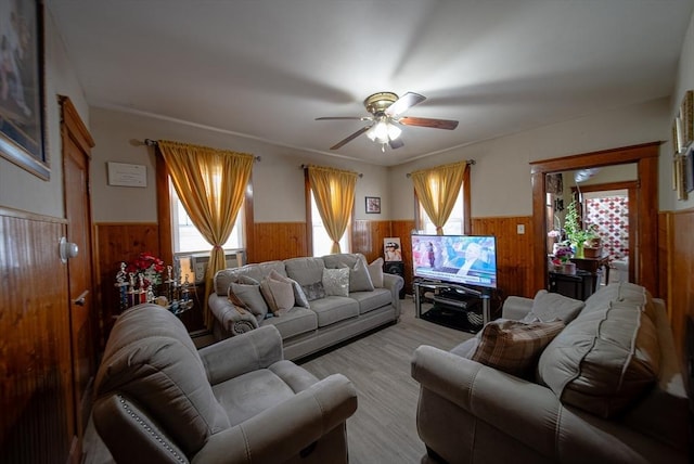 42 Morton St, Lawrence, MA 01841 - living room with wainscoting, wooden walls, plenty of natural light, ceiling fan, and light wood-style floors